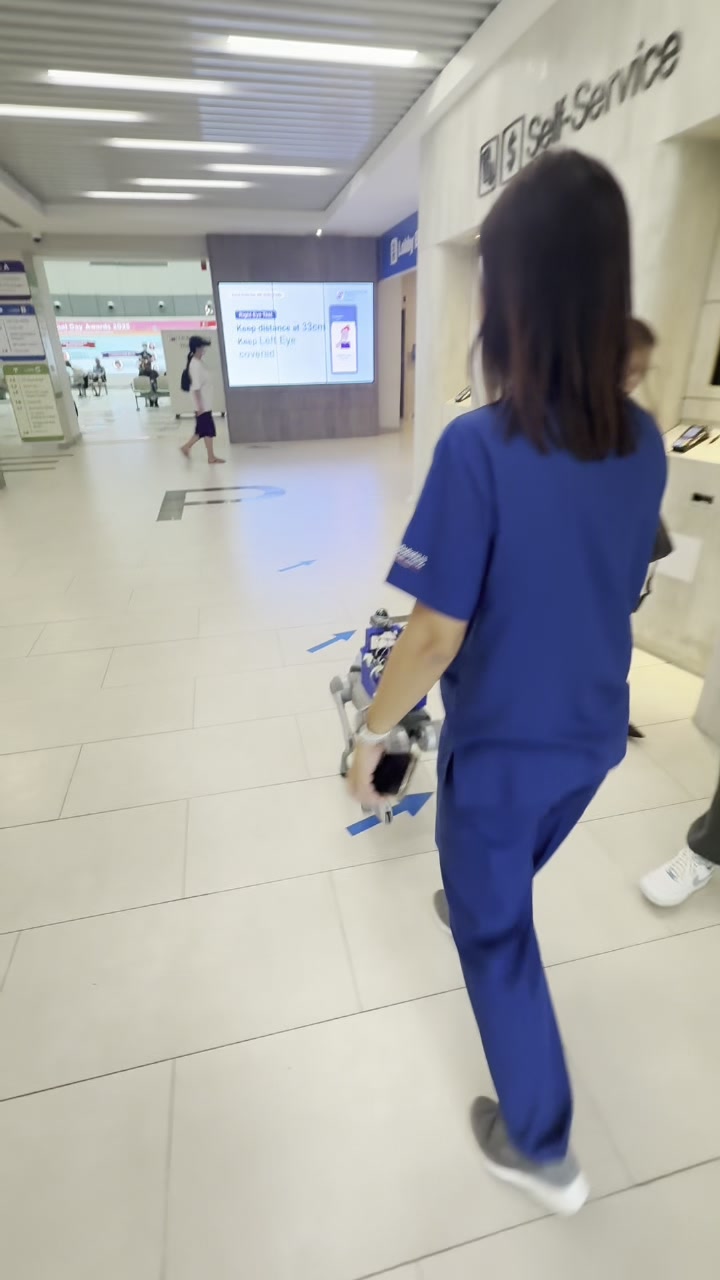 Robotic guide dog guiding a user through a clinic.