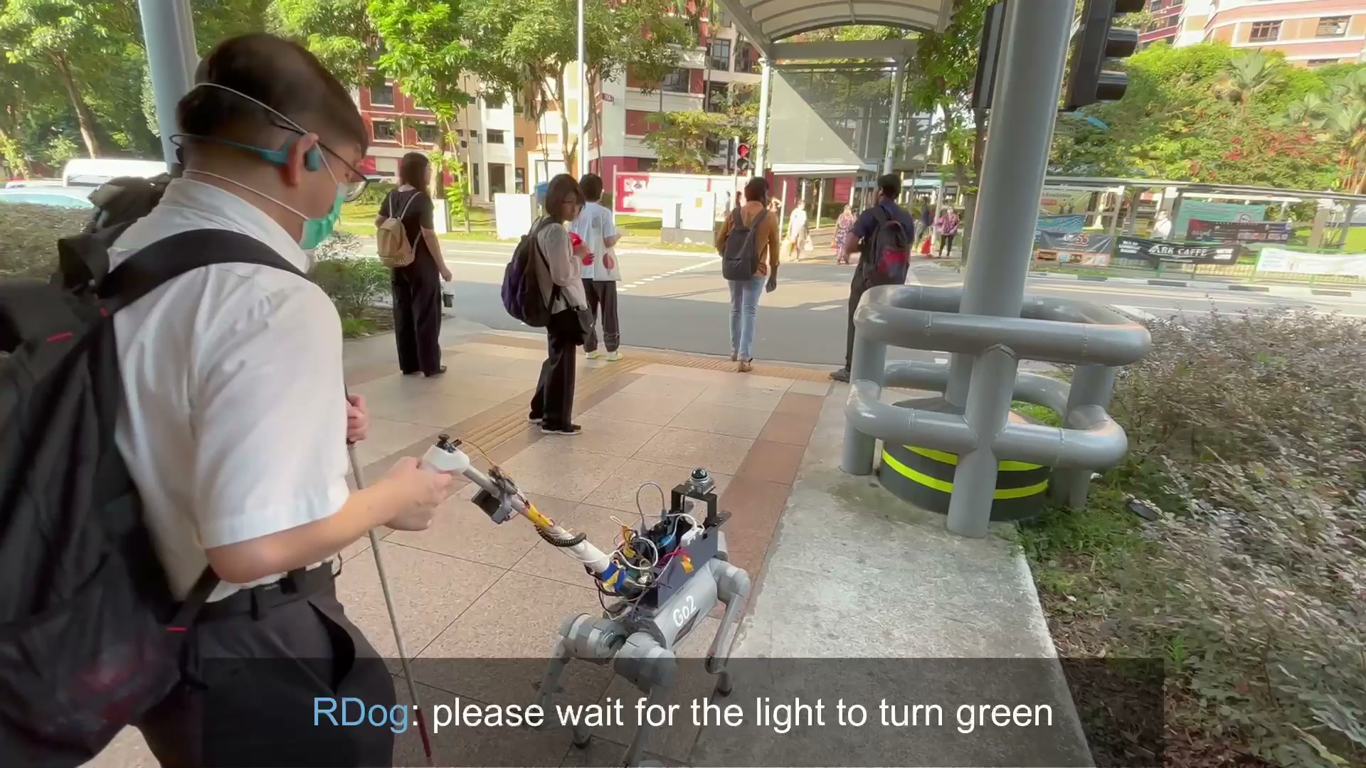 Robotic guide dog at an MRT station crossing.